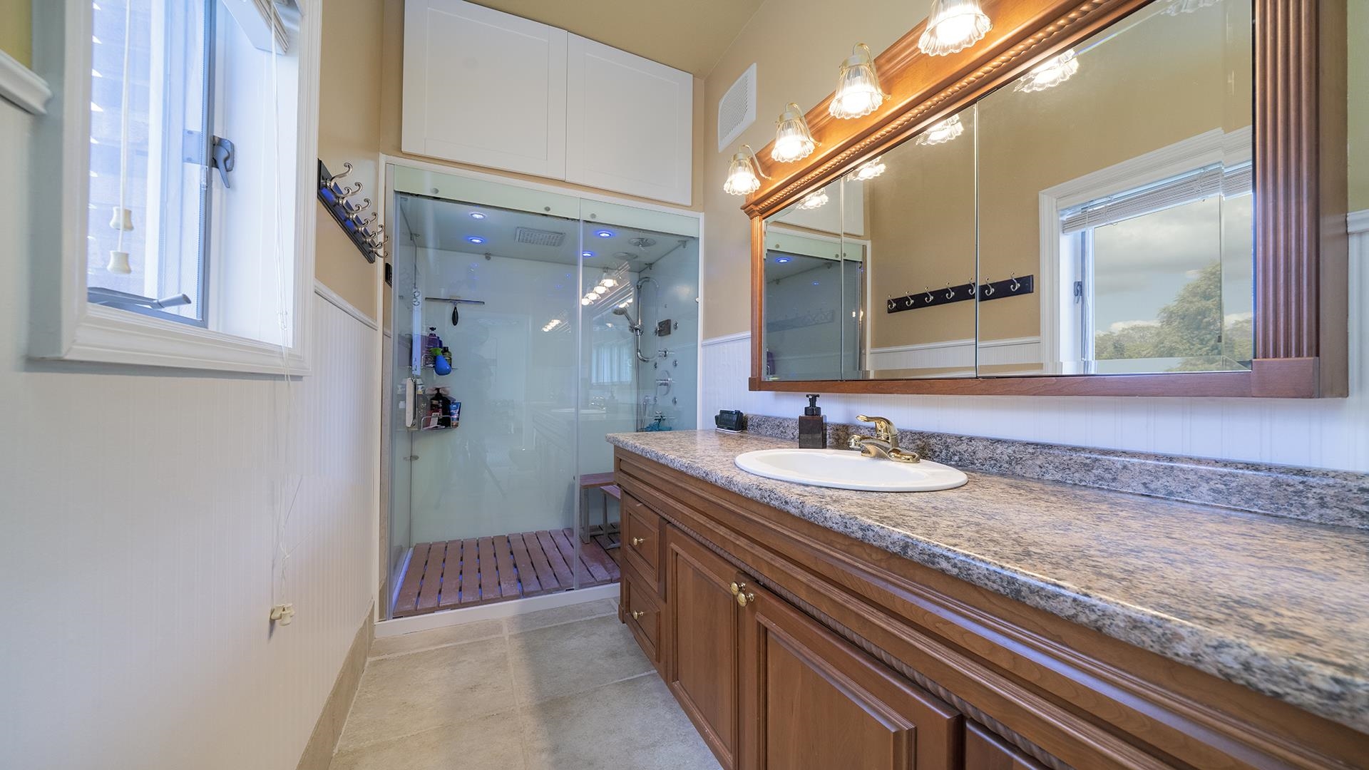 3300 North Silver Ridge Drive Oregon, IL 61061 - Photo 37 of 56 a bathroom with a granite countertop sink and a mirror