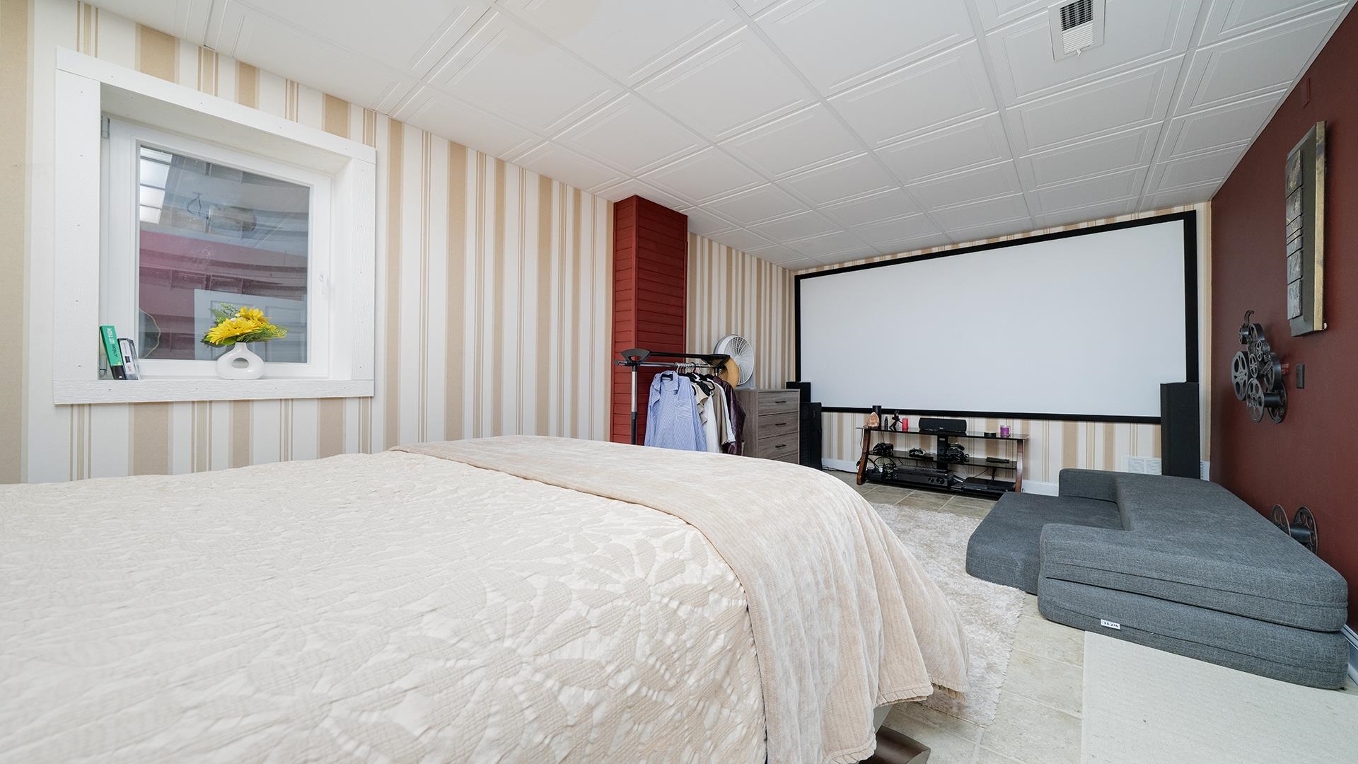 3300 North Silver Ridge Drive Oregon, IL 61061 - Photo 38 of 56 a bedroom with a bed and a flat tv screen on dresser