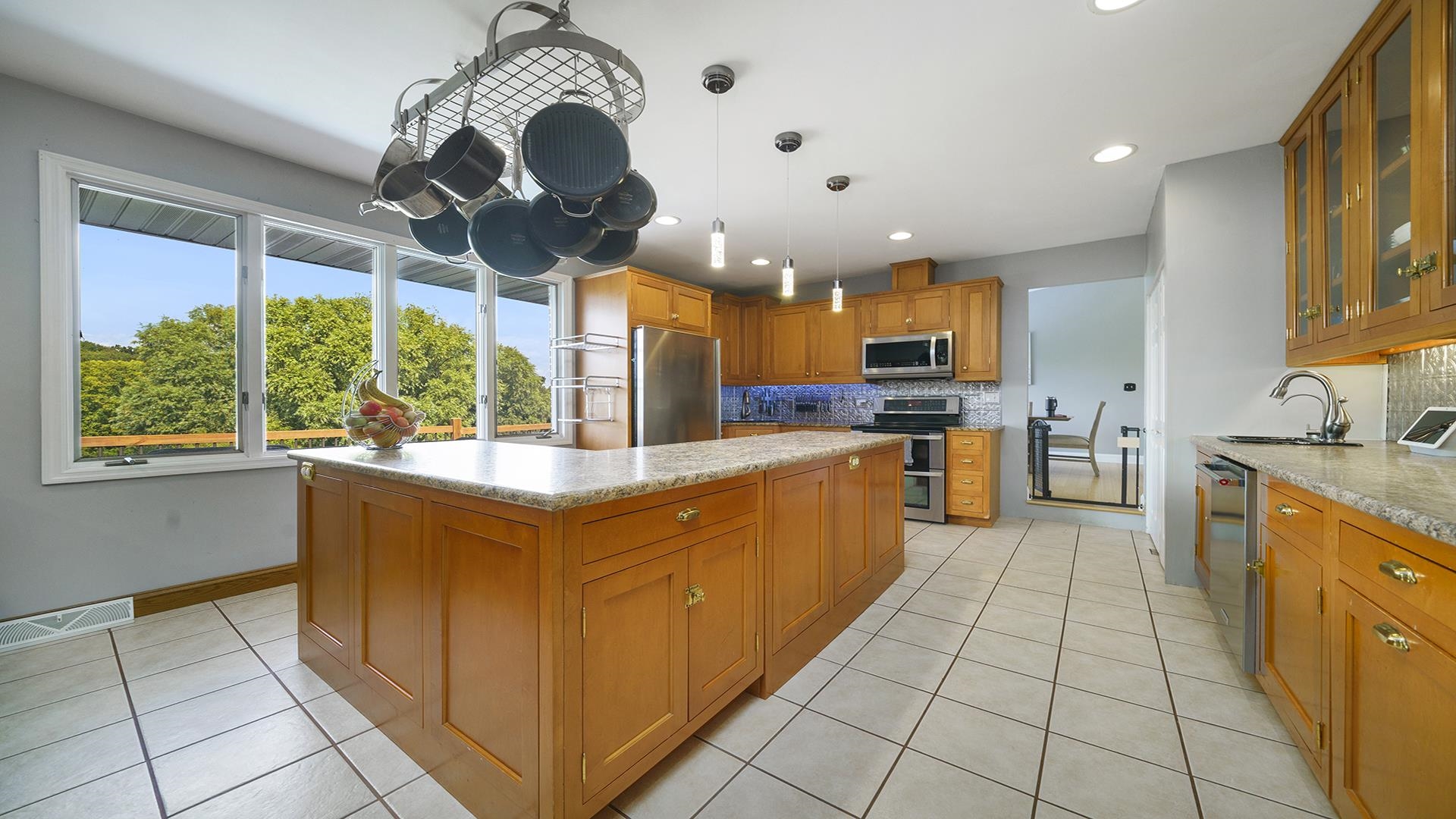 3300 North Silver Ridge Drive Oregon, IL 61061 - Photo 4 of 56 a large kitchen with stainless steel appliances granite countertop a stove and cabinets