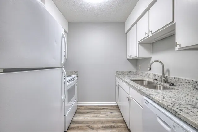 a kitchen with a sink and a refrigerator