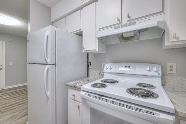 a kitchen with stainless steel appliances a refrigerator and cabinets