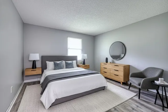 a bedroom with bed chair and window