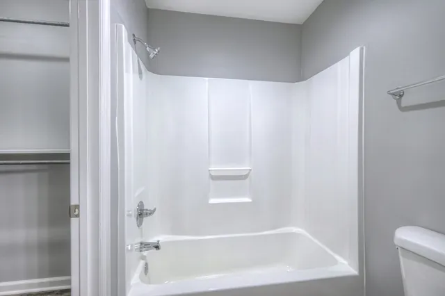 a bathroom with a bathtub and a toilet