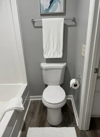 a bathroom with a toilet and a shower