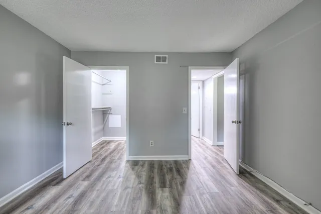 a view of hallway with wooden floor