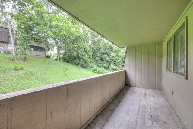 a view of balcony with yard