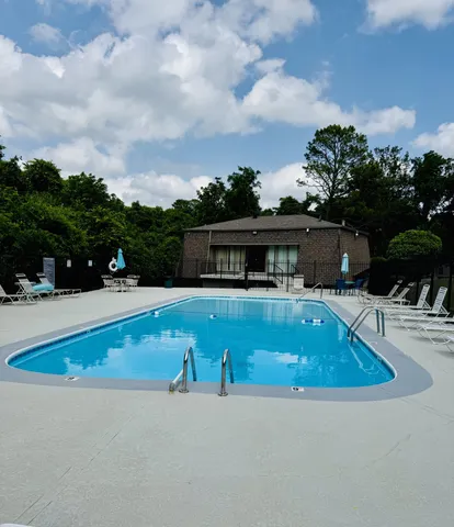 an outdoor view with swimming pool having outdoor seating