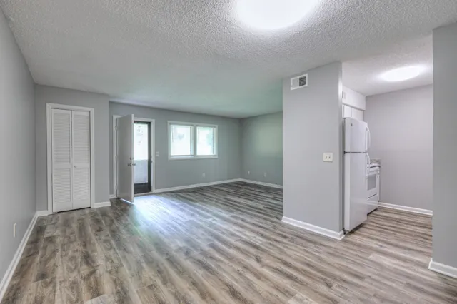 a view of wooden floor and windows in an empty room