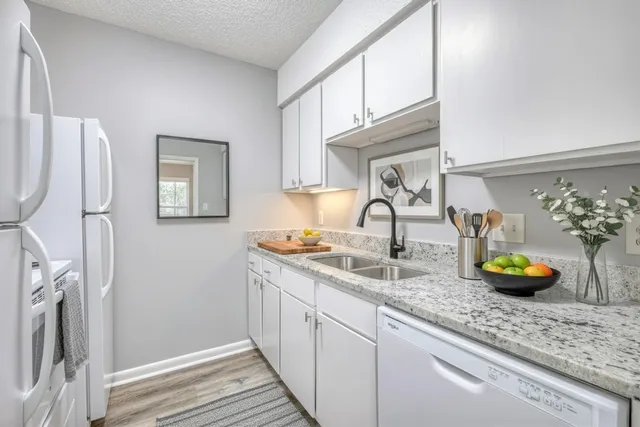 a kitchen with a sink a counter and cabinets