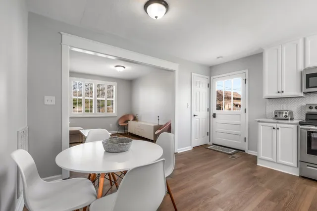 a view of a dining room with furniture and wooden floor