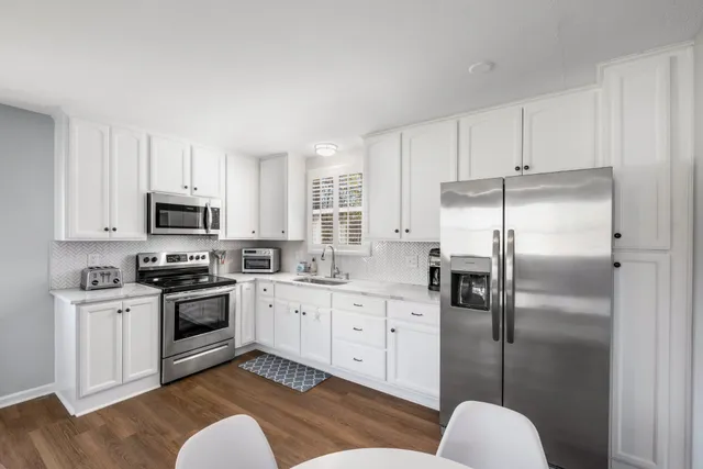 a kitchen with stainless steel appliances granite countertop a refrigerator sink and stove