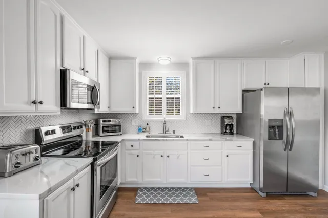a kitchen with a sink stove and refrigerator