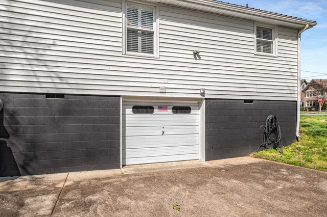 a view of a house with wooden stairs and a small table