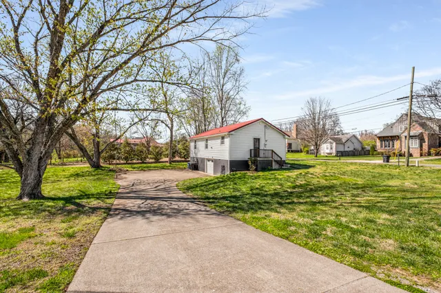 a view of a green field with trees