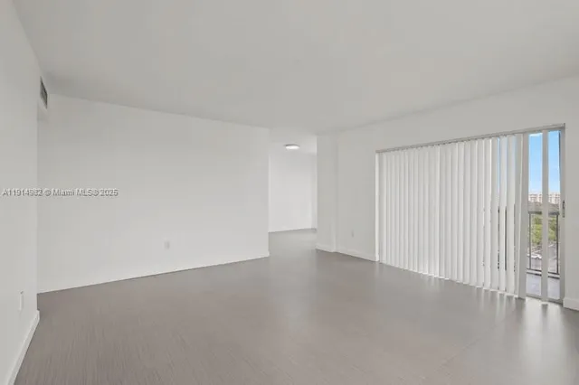 a view of an empty room and wooden floor