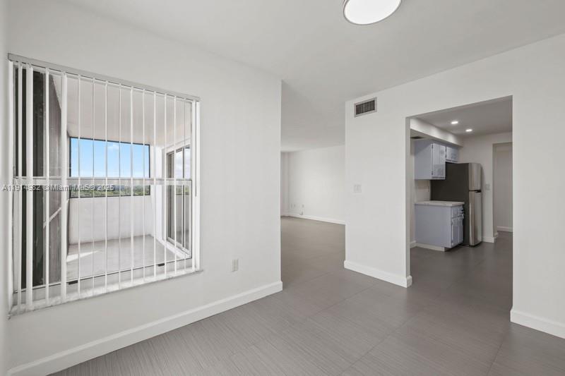 4174 Inverrary Drive, Unit 902 Lauderhill, FL 33319 - Photo 9 of 19 a view of a kitchen with a refrigerator and a sink
