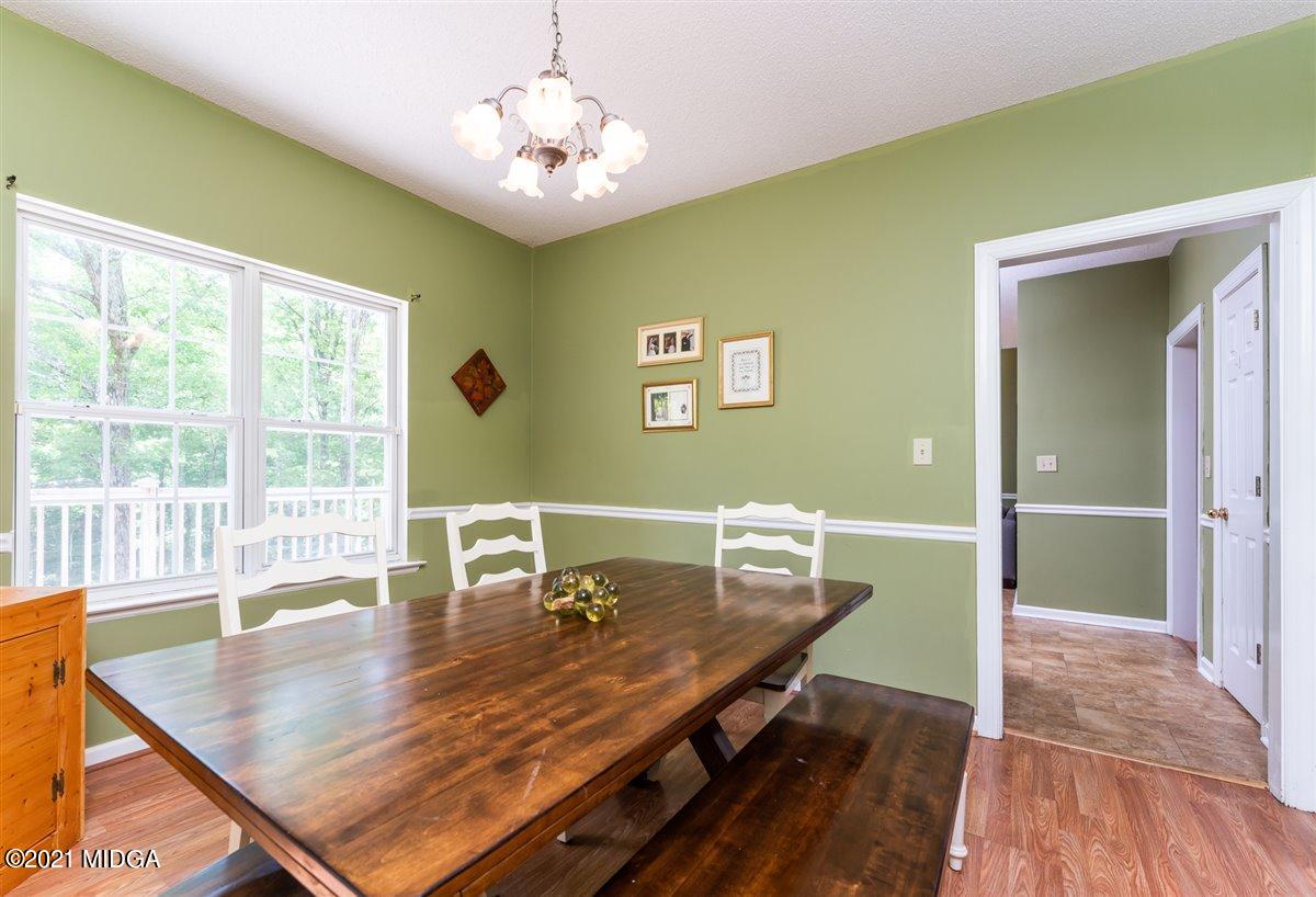 199 Woods Road Juliette, GA 31046 - Photo 12 of 38 a dining room with furniture a rug and wooden floor