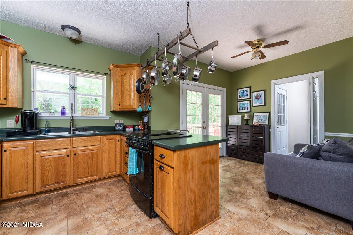199 Woods Road Juliette, GA 31046 - Photo 13 of 38 a kitchen with stainless steel appliances granite countertop a sink and a refrigerator