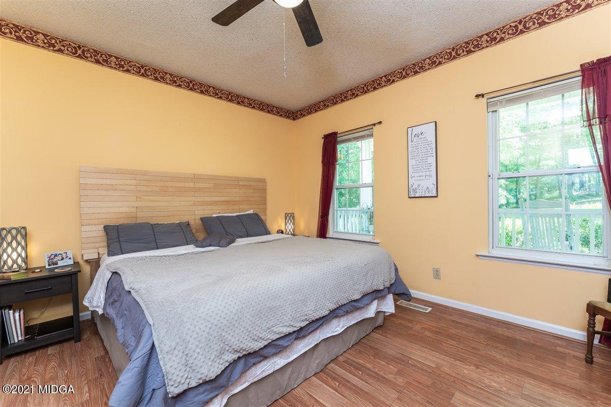 199 Woods Road Juliette, GA 31046 - Photo 19 of 38 a bedroom with a bed a dresser next to a window