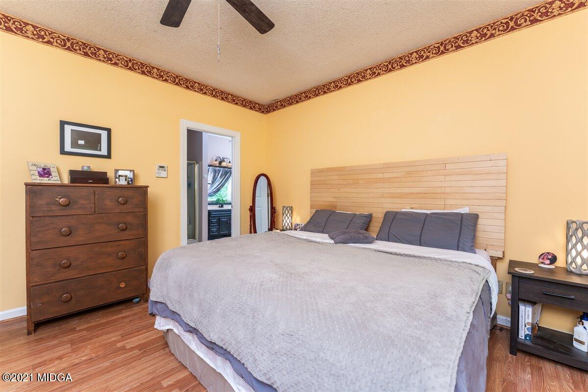 199 Woods Road Juliette, GA 31046 - Photo 20 of 38 a bed sitting in a bedroom and dresser