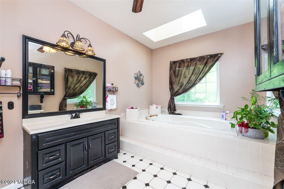 199 Woods Road Juliette, GA 31046 - Photo 21 of 38 a bathroom with a sink mirror and window