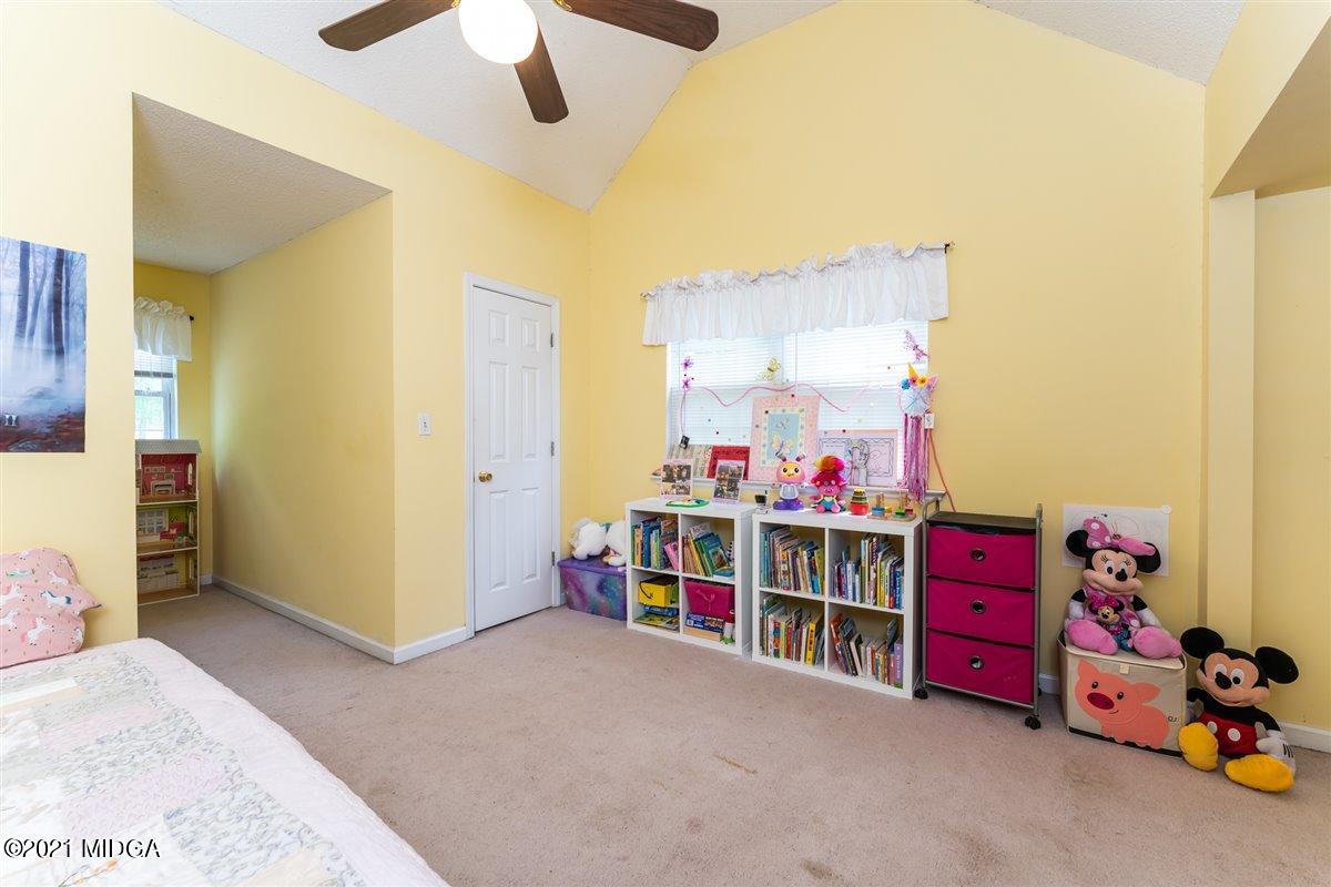 199 Woods Road Juliette, GA 31046 - Photo 27 of 38 a view of a bedroom with baby crib and toys