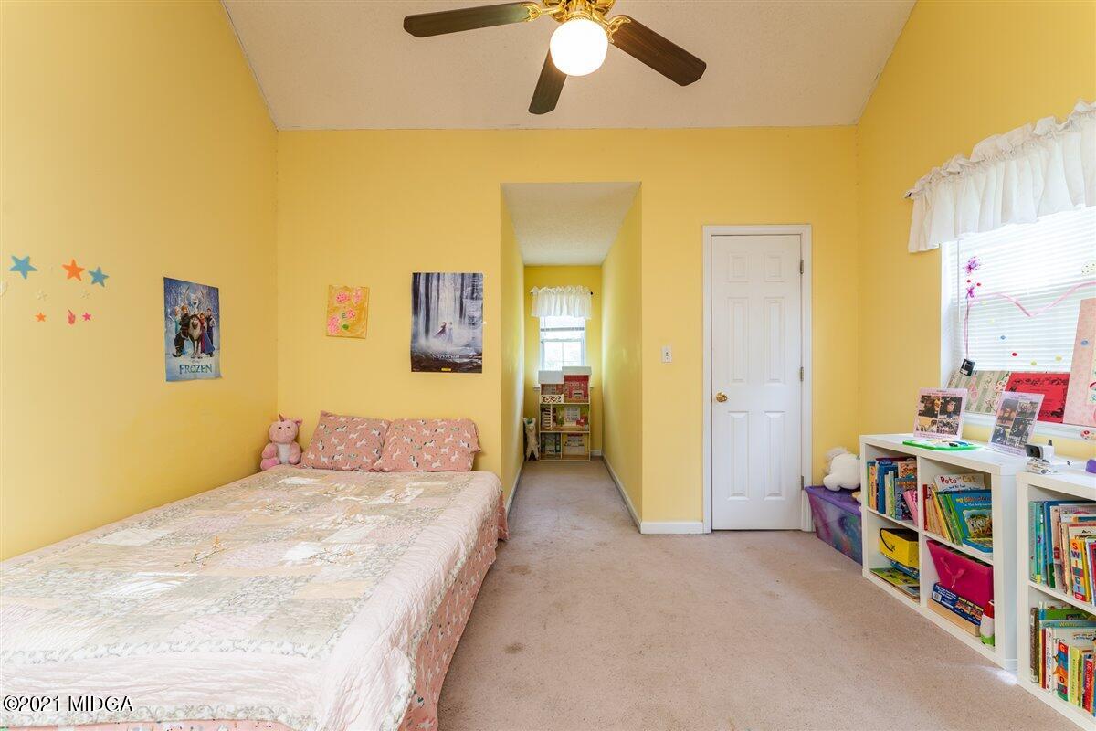 199 Woods Road Juliette, GA 31046 - Photo 29 of 38 a bedroom with a bed and a chandelier