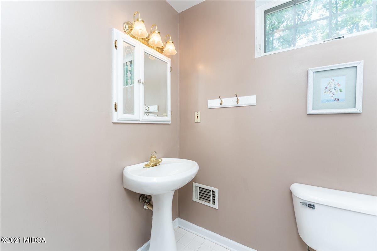 199 Woods Road Juliette, GA 31046 - Photo 30 of 38 a bathroom with a toilet sink and mirror