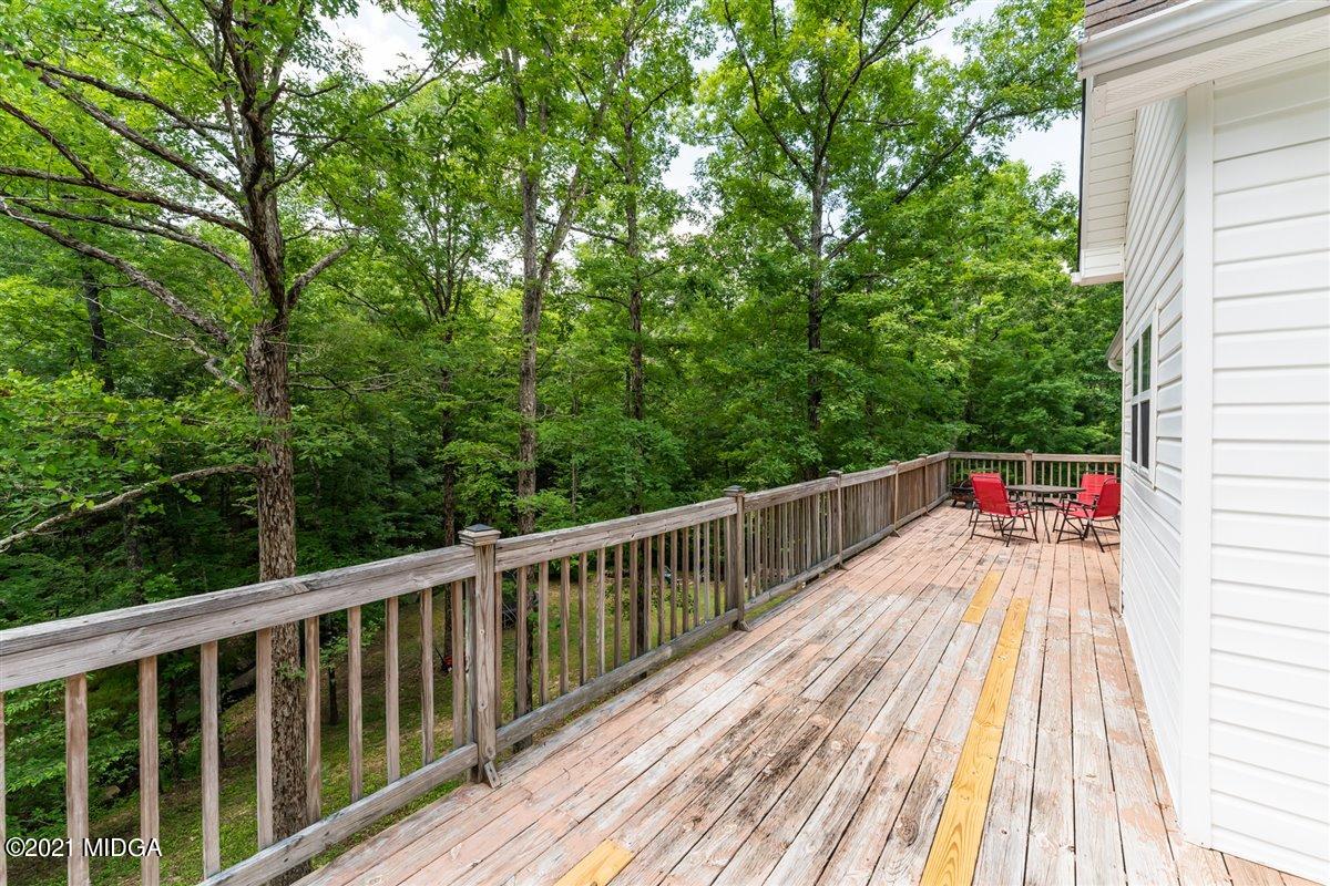 199 Woods Road Juliette, GA 31046 - Photo 33 of 38 a balcony with wooden floor and trees in the back