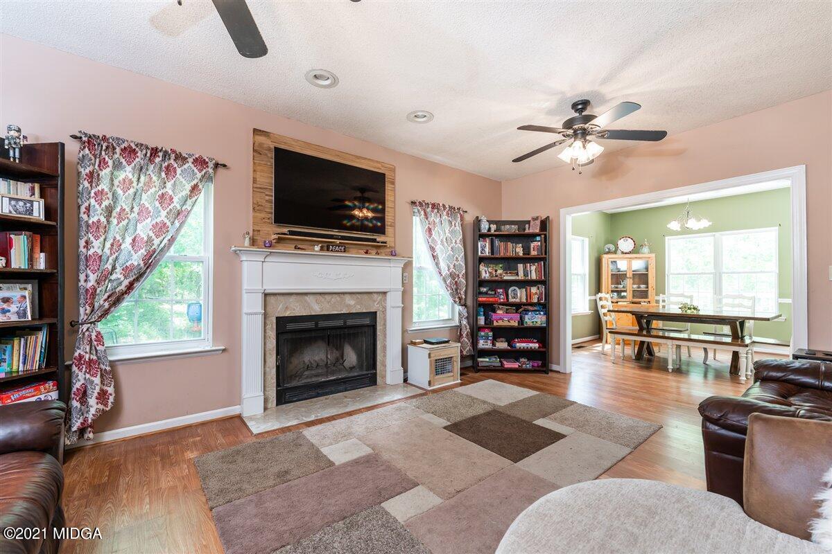 199 Woods Road Juliette, GA 31046 - Photo 7 of 38 a living room with furniture a flat screen tv and a fireplace