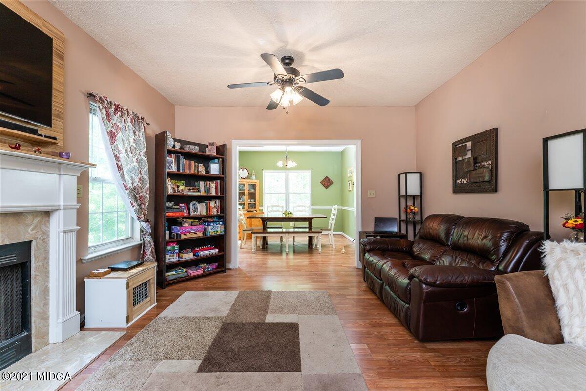 199 Woods Road Juliette, GA 31046 - Photo 8 of 38 a living room with furniture and a fireplace