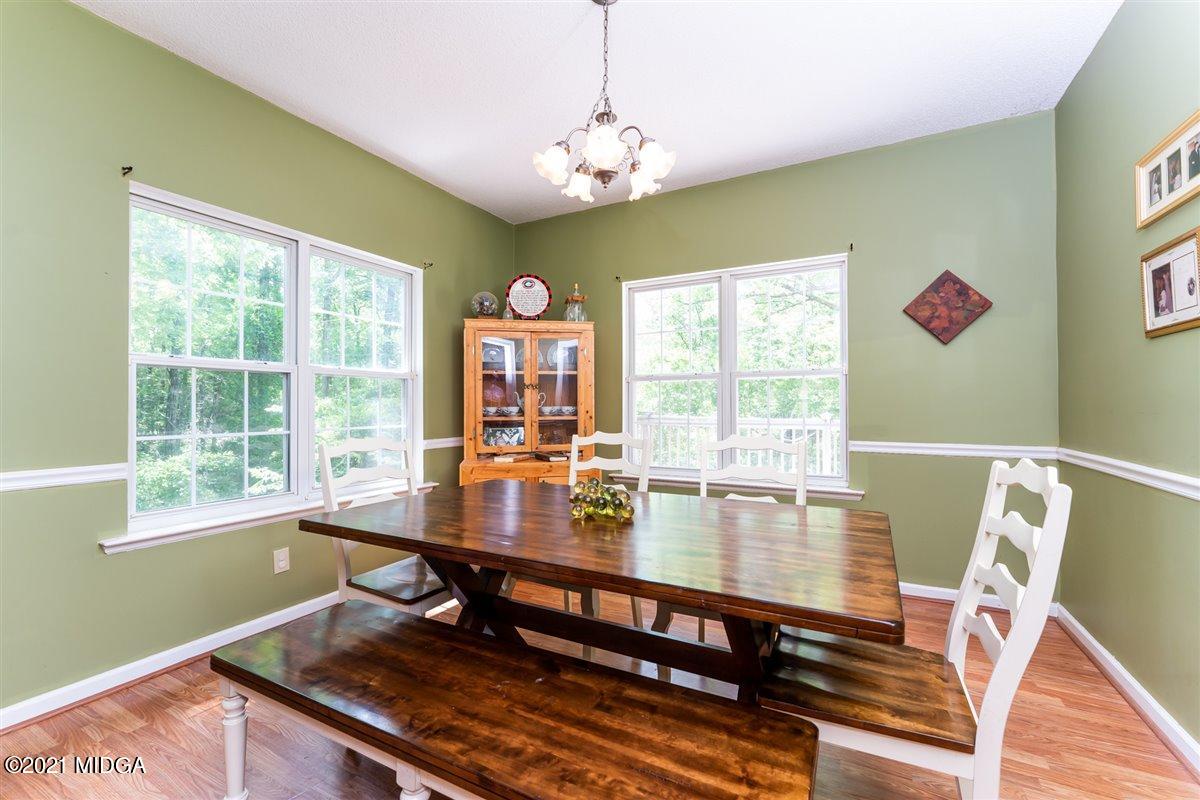 199 Woods Road Juliette, GA 31046 - Photo 9 of 38 a dining room with wooden floor and a window