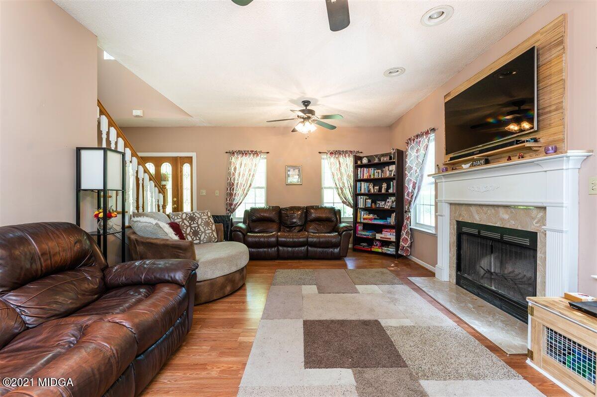 199 Woods Road Juliette, GA 31046 - Photo 10 of 38 a living room with furniture fireplace and flat screen tv