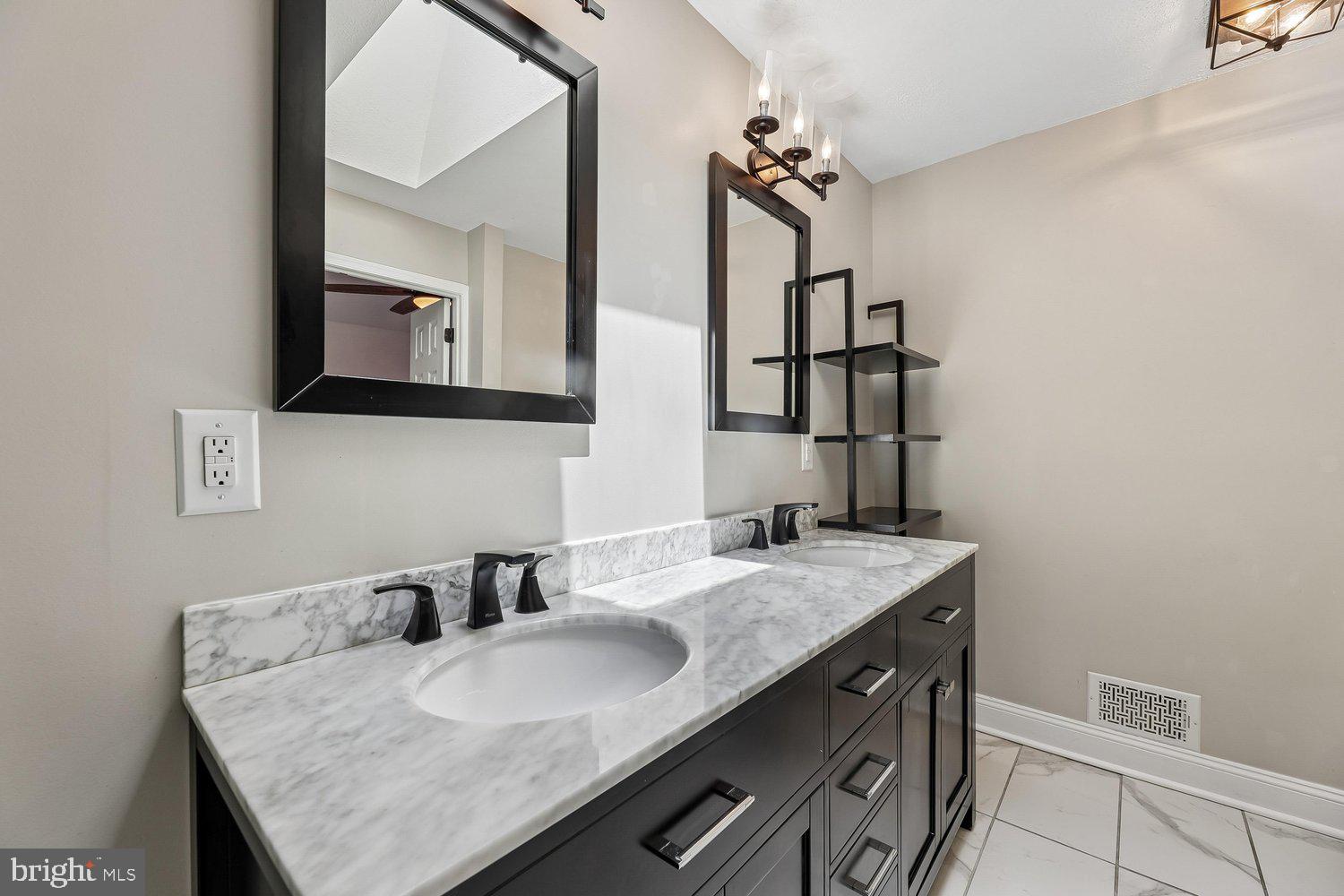 15764 Beau Ridge Drive Woodbridge, VA 22193 - Photo 24 of 58 a bathroom with a granite countertop sink a mirror and vanity