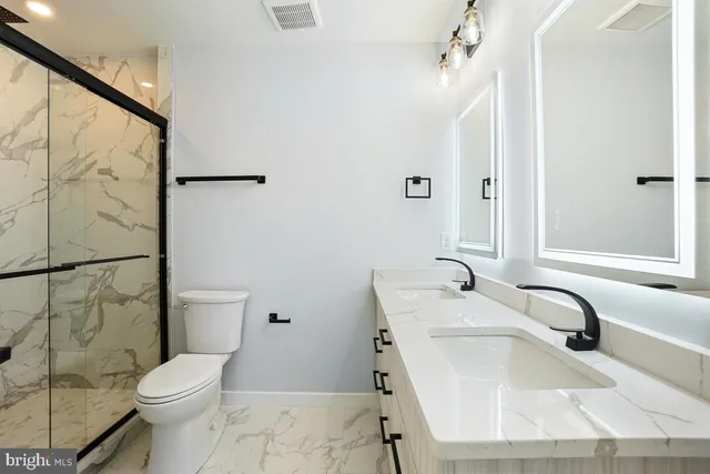 a bathroom with a sink toilet and shower