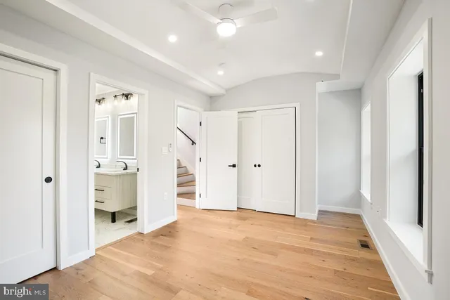 a view of a hallway with wooden shelves