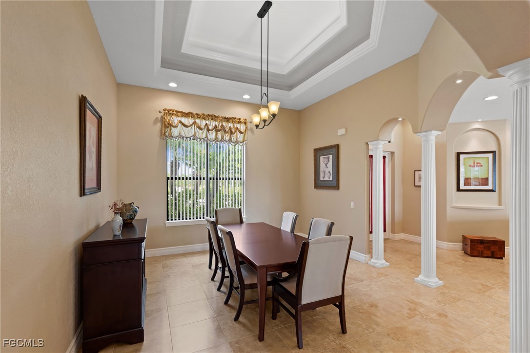 6057 Calusa Rdg Trail Bokeelia, FL 33922 - Photo 6 of 45 a dining room with furniture a chandelier and window