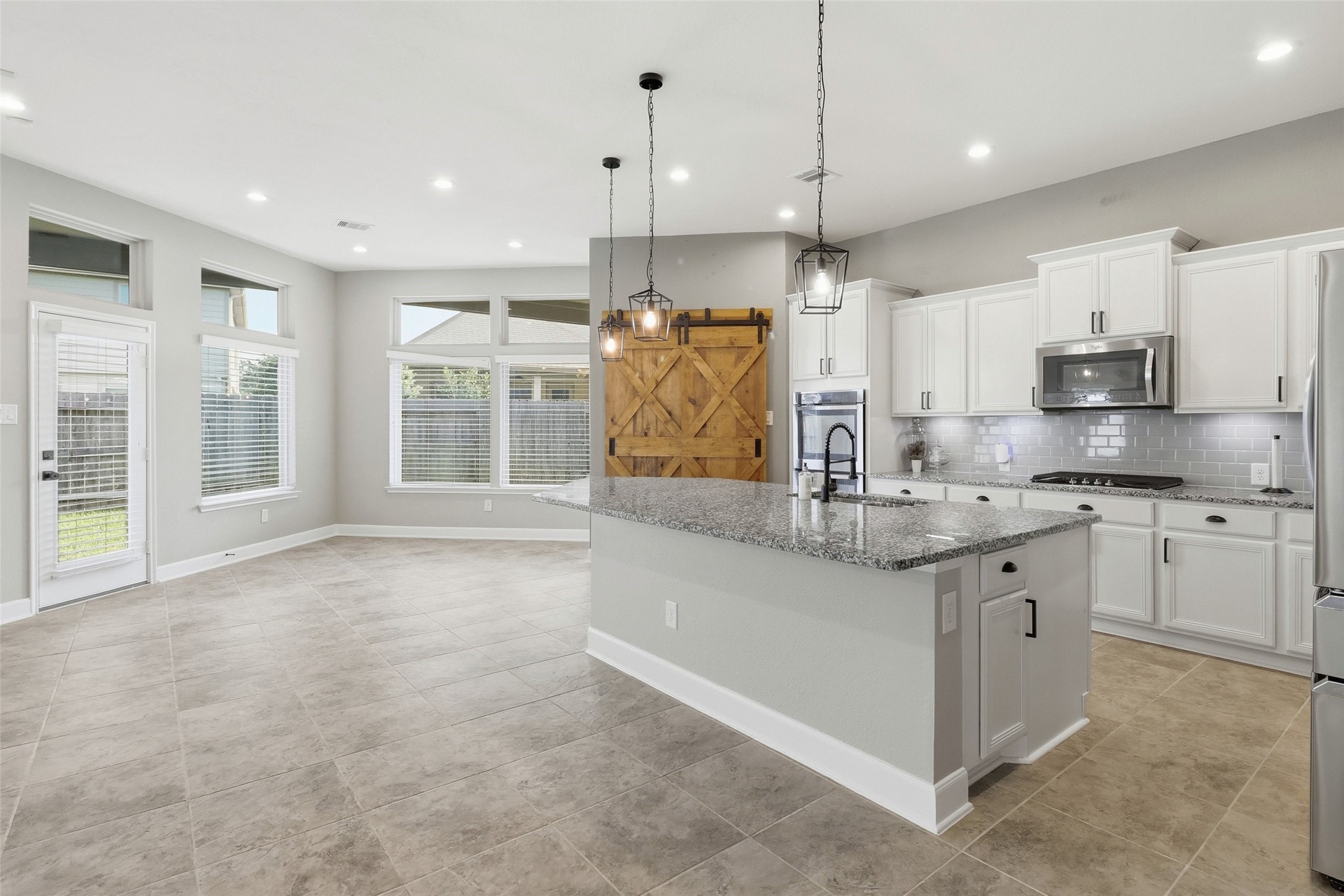 24126 Cane Fields Road Katy, TX 77493 - Photo 10 of 36 Beautifully updated kitchen with modern cabinet hardware, designer pendant lighting, abundant cabinetry, and a spacious layout ideal for entertaining.