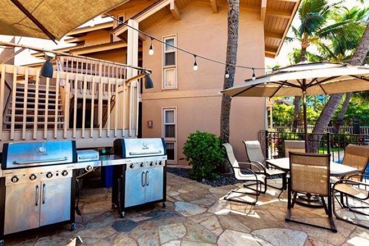 115 North Kihei Road, Unit A3 Kihei, HI 96753 - Photo 15 of 21 a view of a patio with a table and chairs under an umbrella