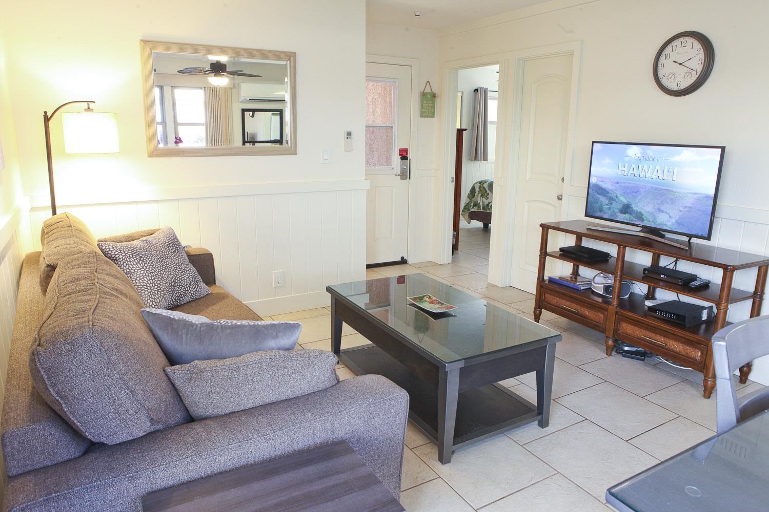 115 North Kihei Road, Unit A3 Kihei, HI 96753 - Photo 2 of 21 a living room with furniture and a flat screen tv
