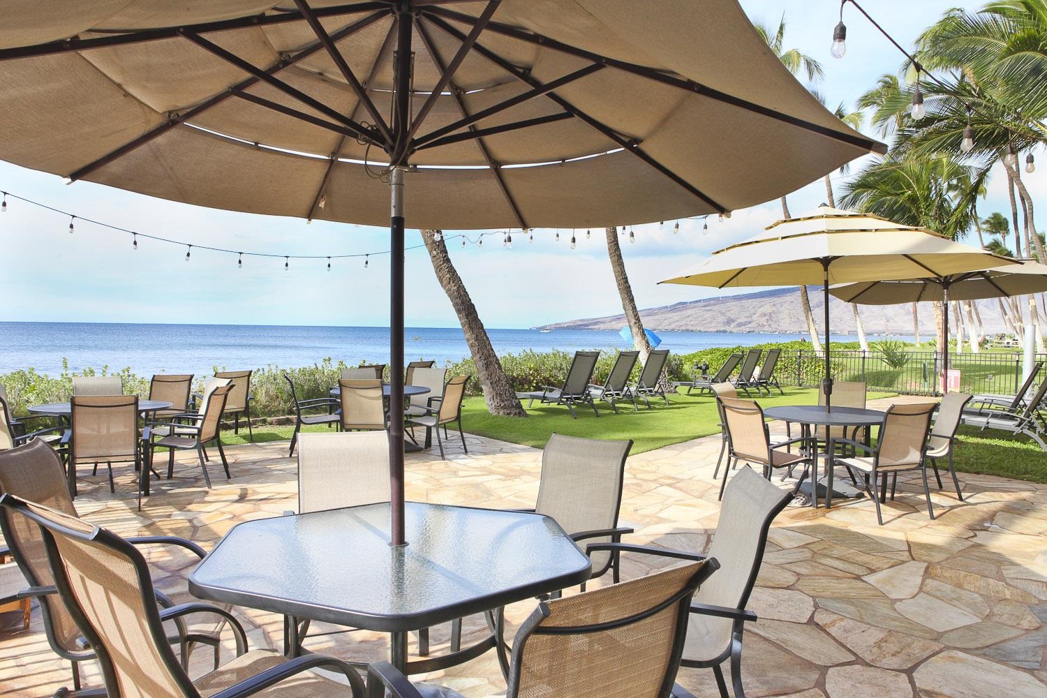 115 North Kihei Road, Unit A3 Kihei, HI 96753 - Photo 21 of 21 a view of a patio with table and chairs under an umbrella