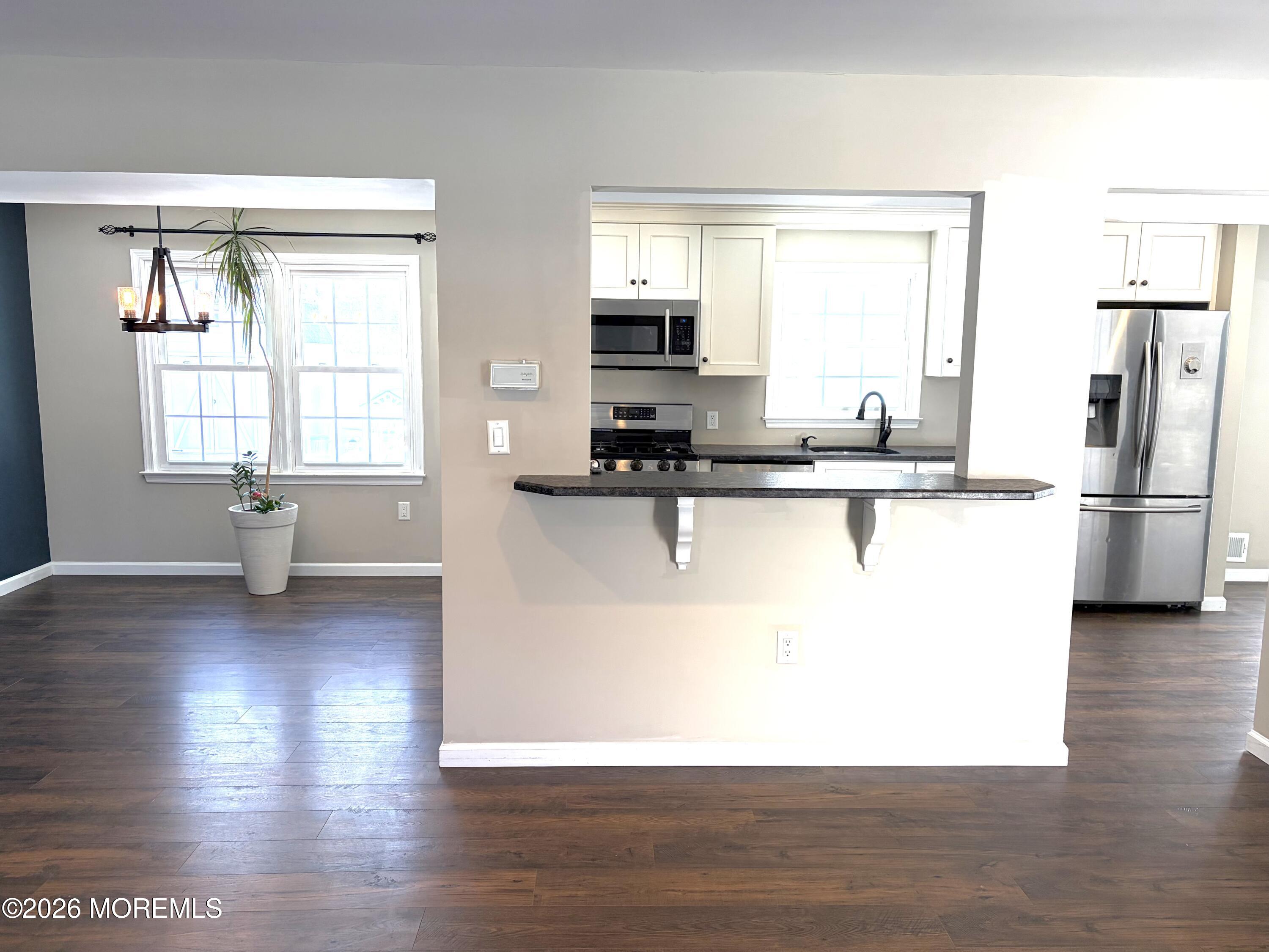 295 Flaam Street Toms River, NJ 08753 - Photo 12 of 30 a view of a kitchen counter space with wooden floor and kitchen view