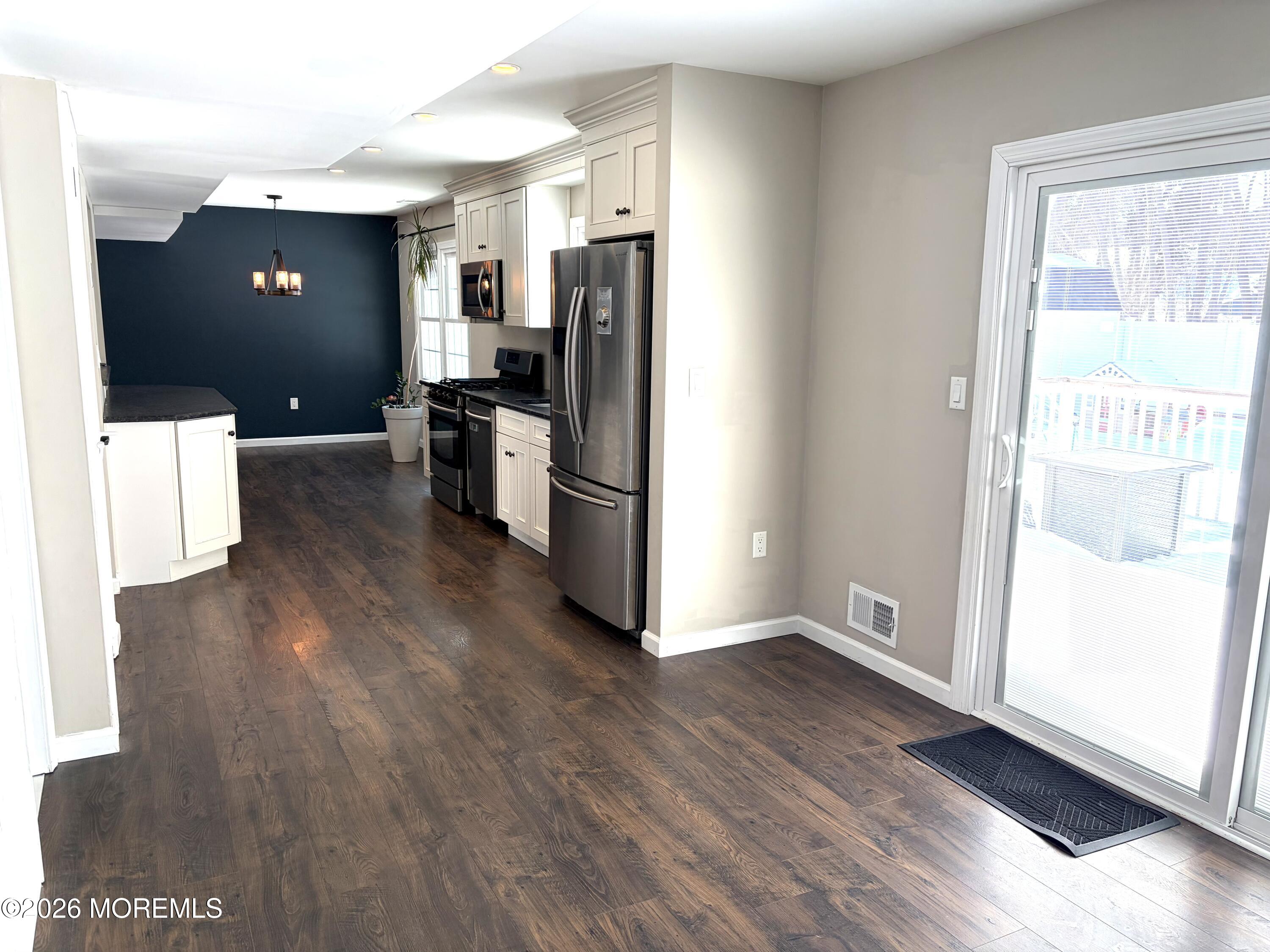 295 Flaam Street Toms River, NJ 08753 - Photo 15 of 30 a kitchen with a refrigerator and a stove top oven