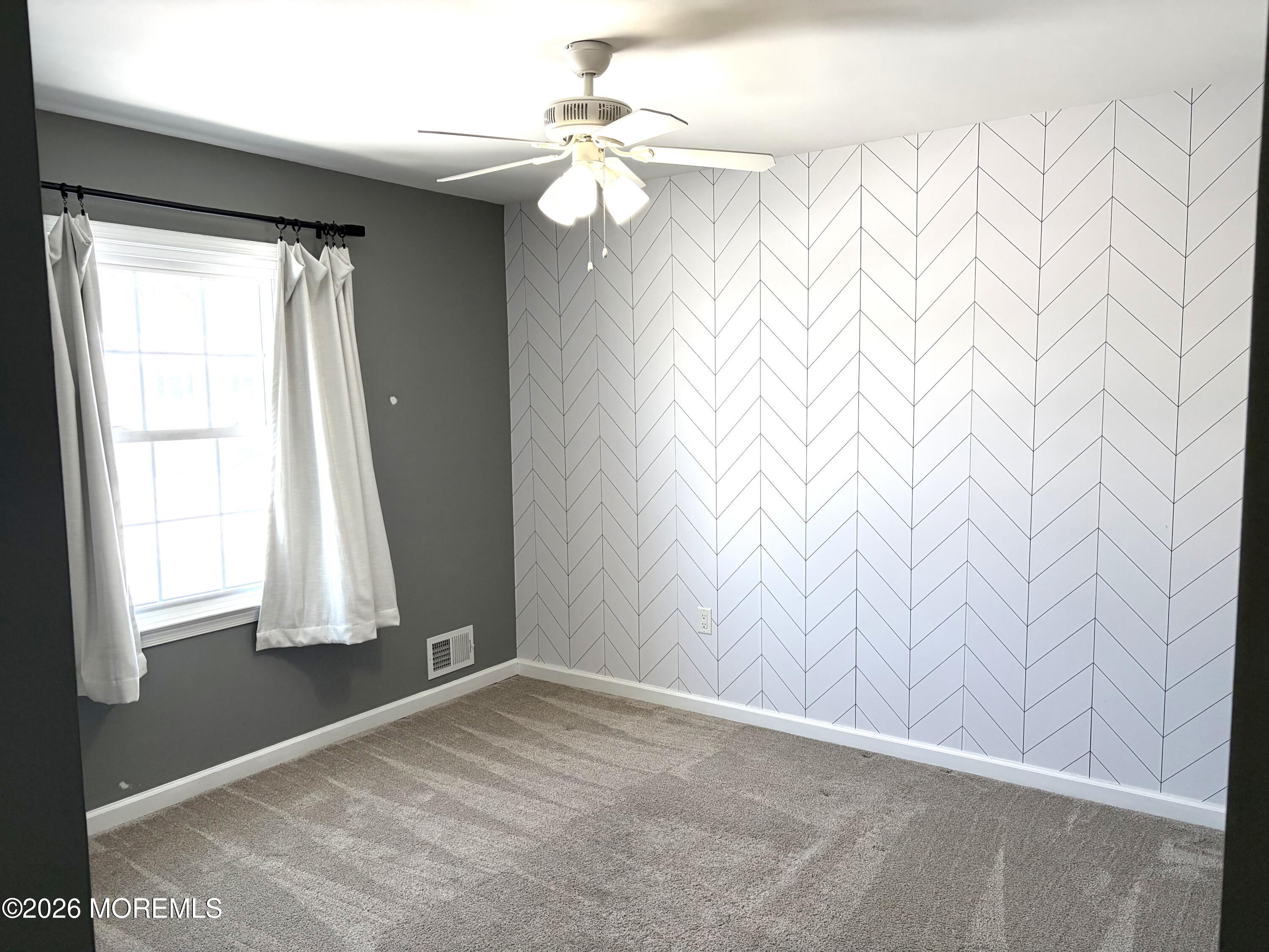 295 Flaam Street Toms River, NJ 08753 - Photo 19 of 30 an empty room with windows and fan