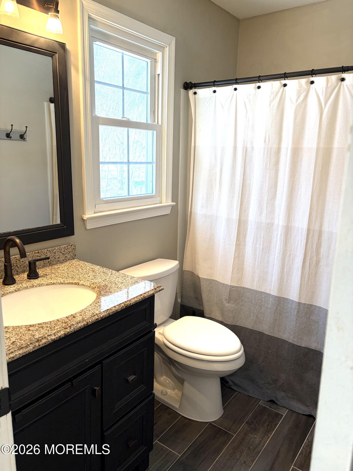 295 Flaam Street Toms River, NJ 08753 - Photo 23 of 30 a bathroom with a granite countertop sink toilet and shower