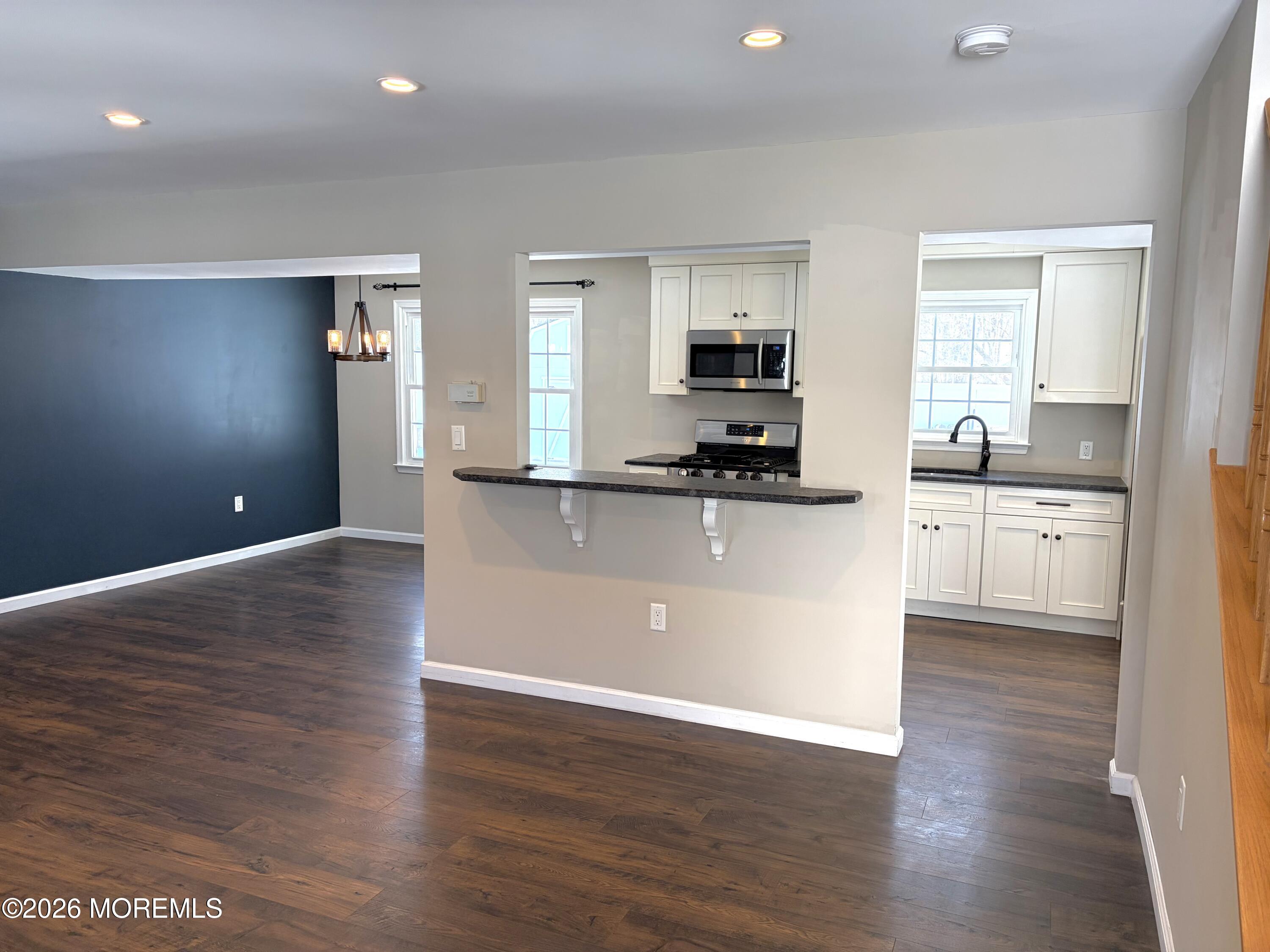 295 Flaam Street Toms River, NJ 08753 - Photo 3 of 30 a view of a kitchen with cabinets stainless steel appliances a sink and a window