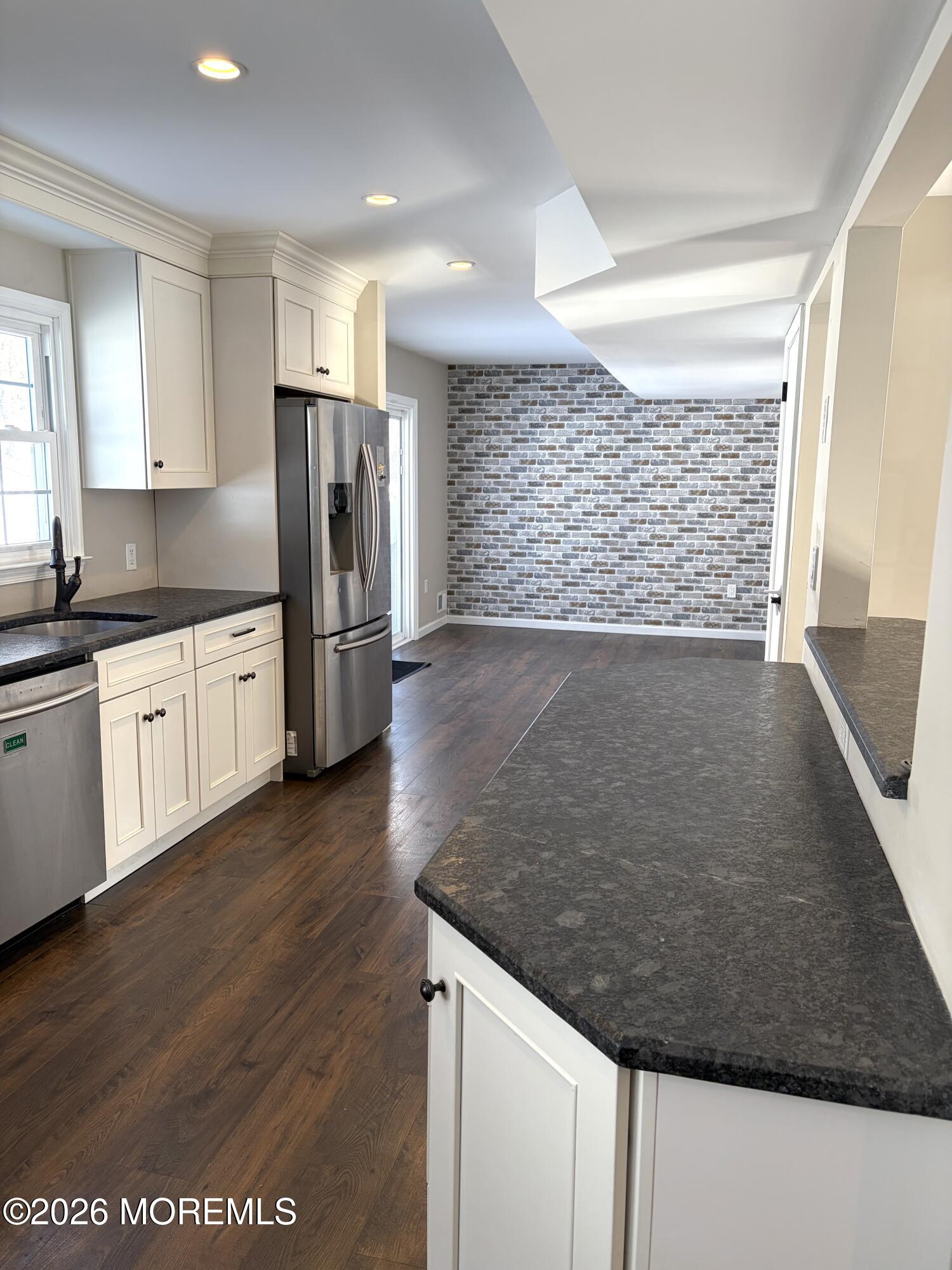 295 Flaam Street Toms River, NJ 08753 - Photo 6 of 30 a view of a kitchen with a sink wooden floor and a refrigerator