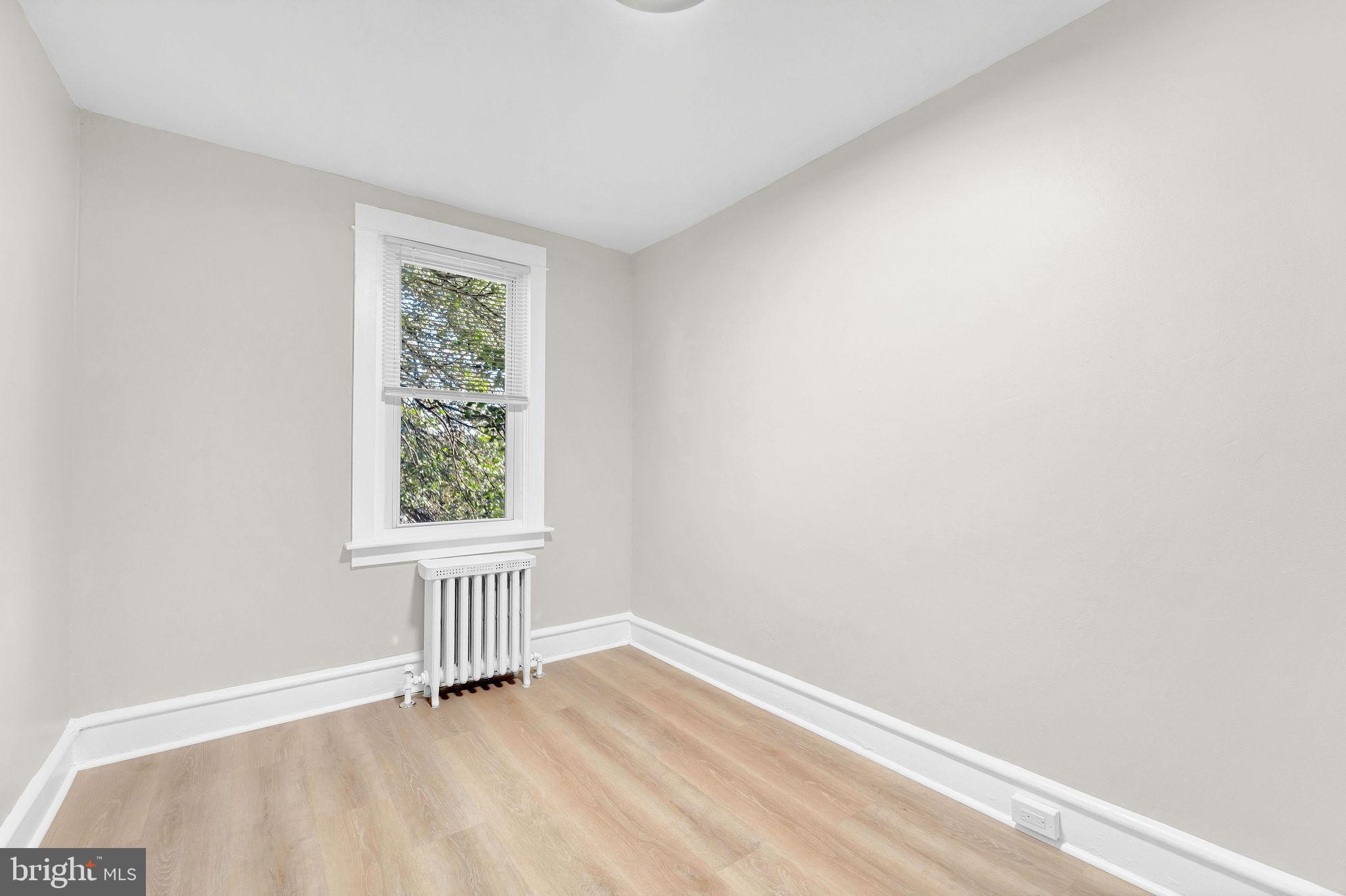 2791 Yorkship Road Camden, NJ 08104 - Photo 19 of 33 an empty room with wooden floor and windows