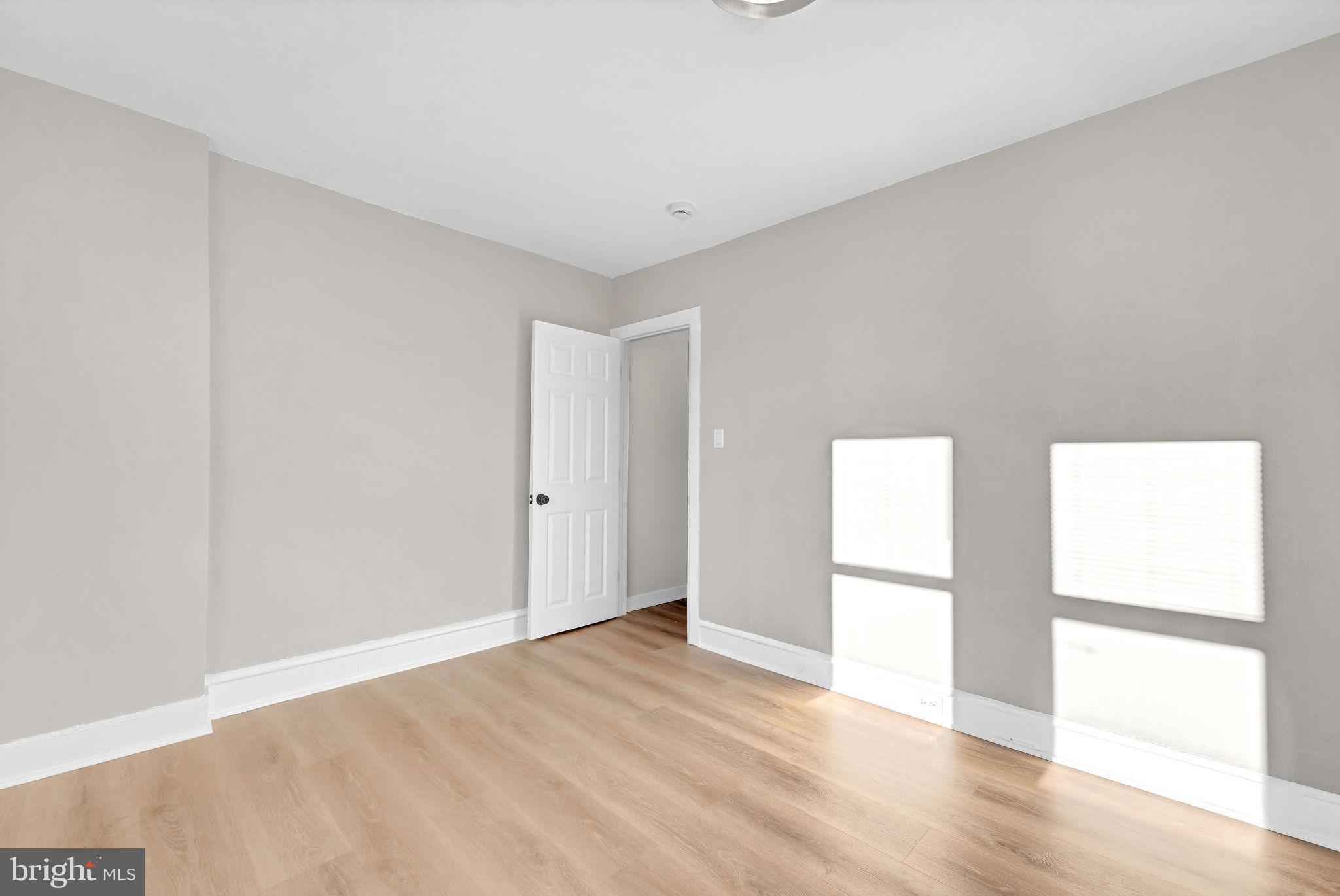 2791 Yorkship Road Camden, NJ 08104 - Photo 22 of 33 a view of an empty room with wooden floor and a window