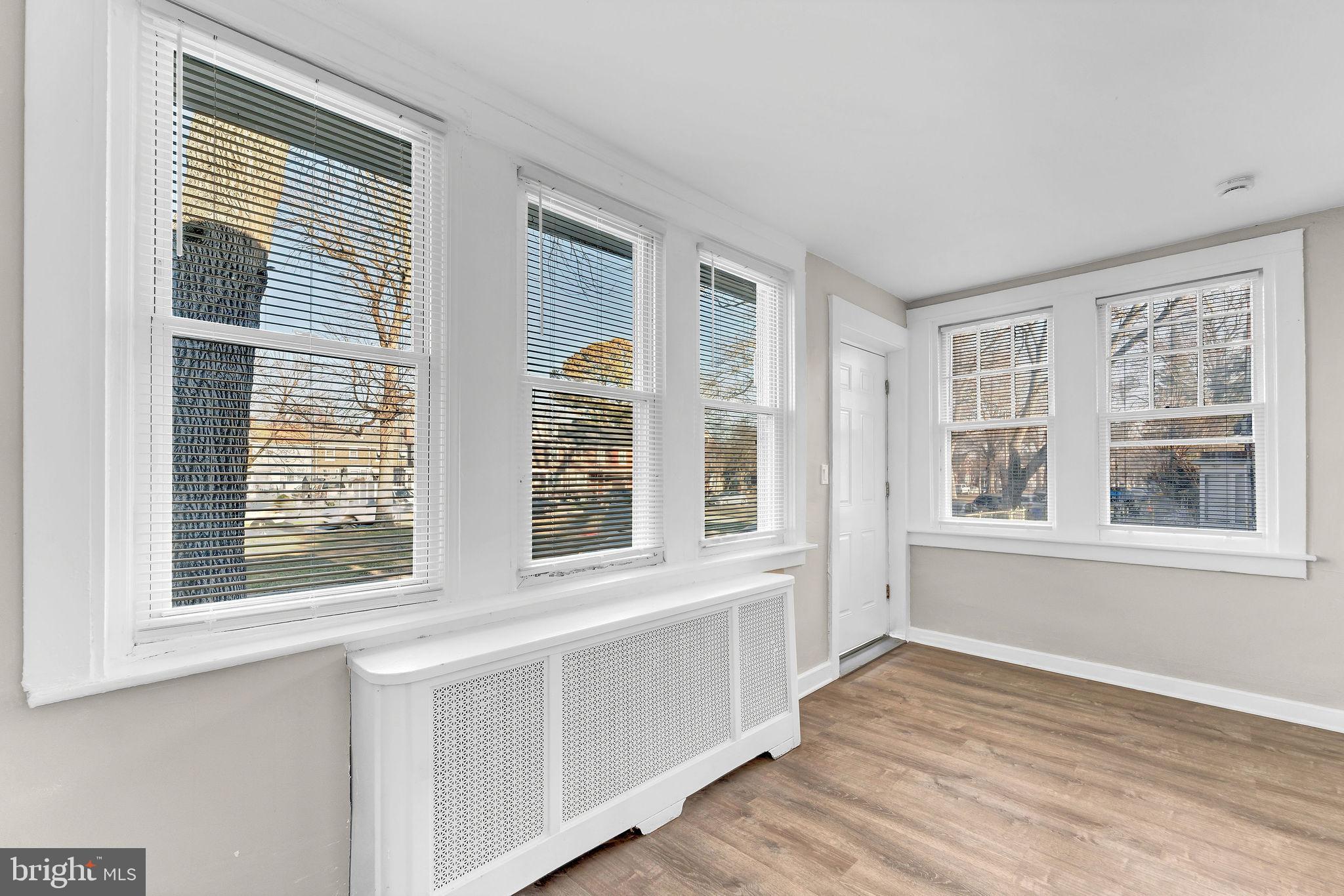 2791 Yorkship Road Camden, NJ 08104 - Photo 4 of 33 a view of an empty room with wooden floor and windows